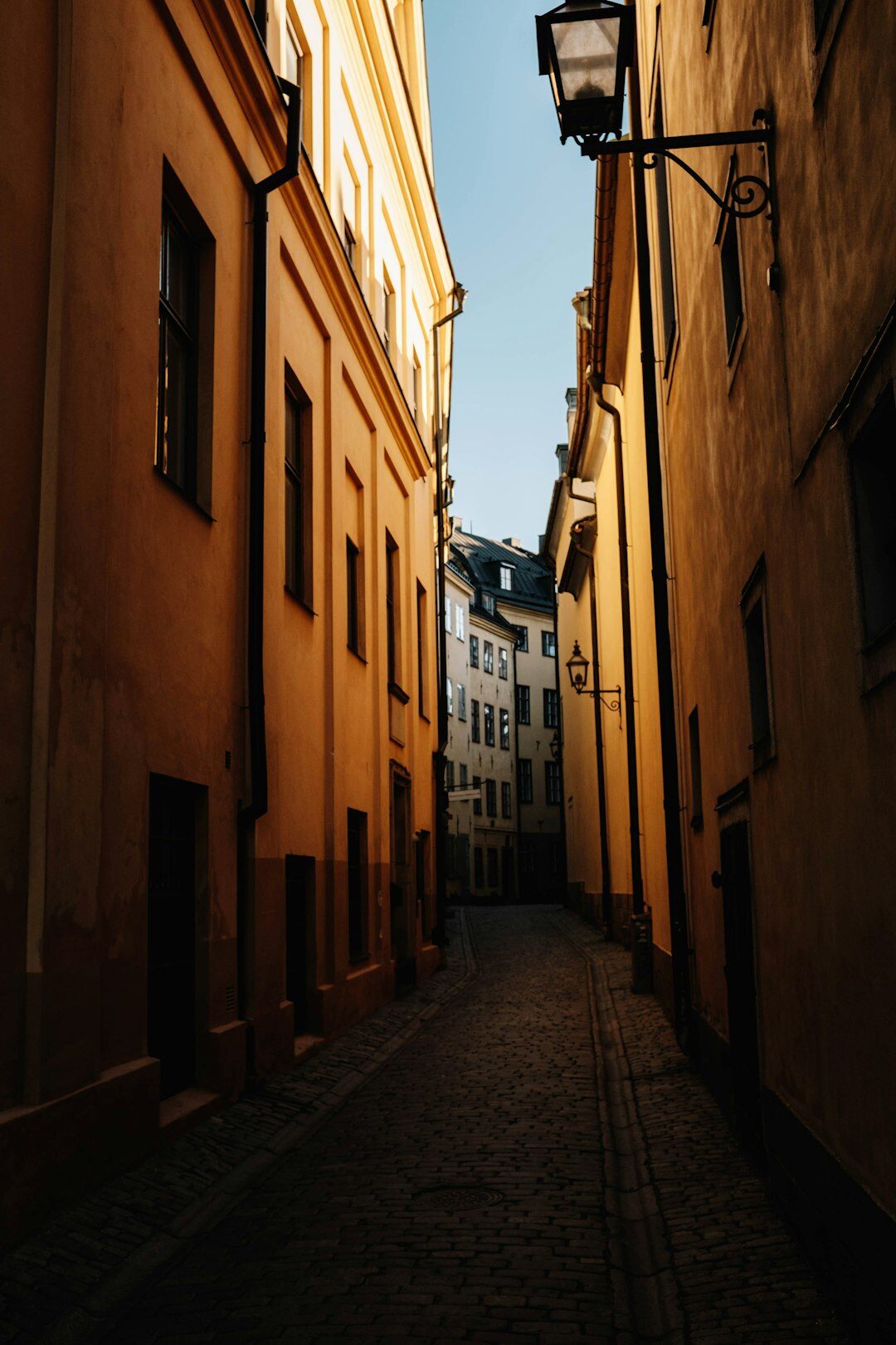 Narrow stone alley between old European townhouses
