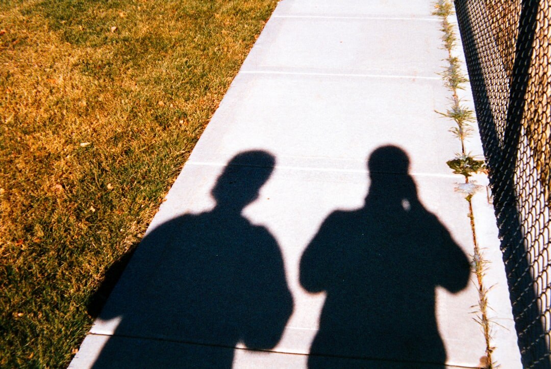 two people whispering in shadows