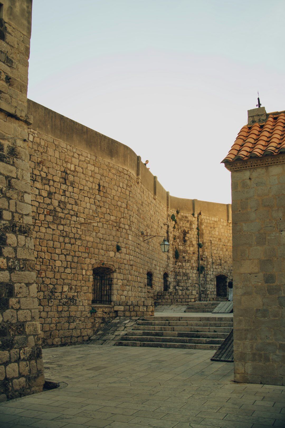 Stone courtyard of an old medieval castle at dusk