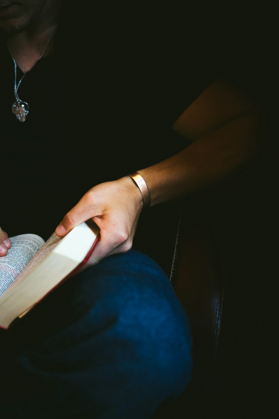 person reading book at night